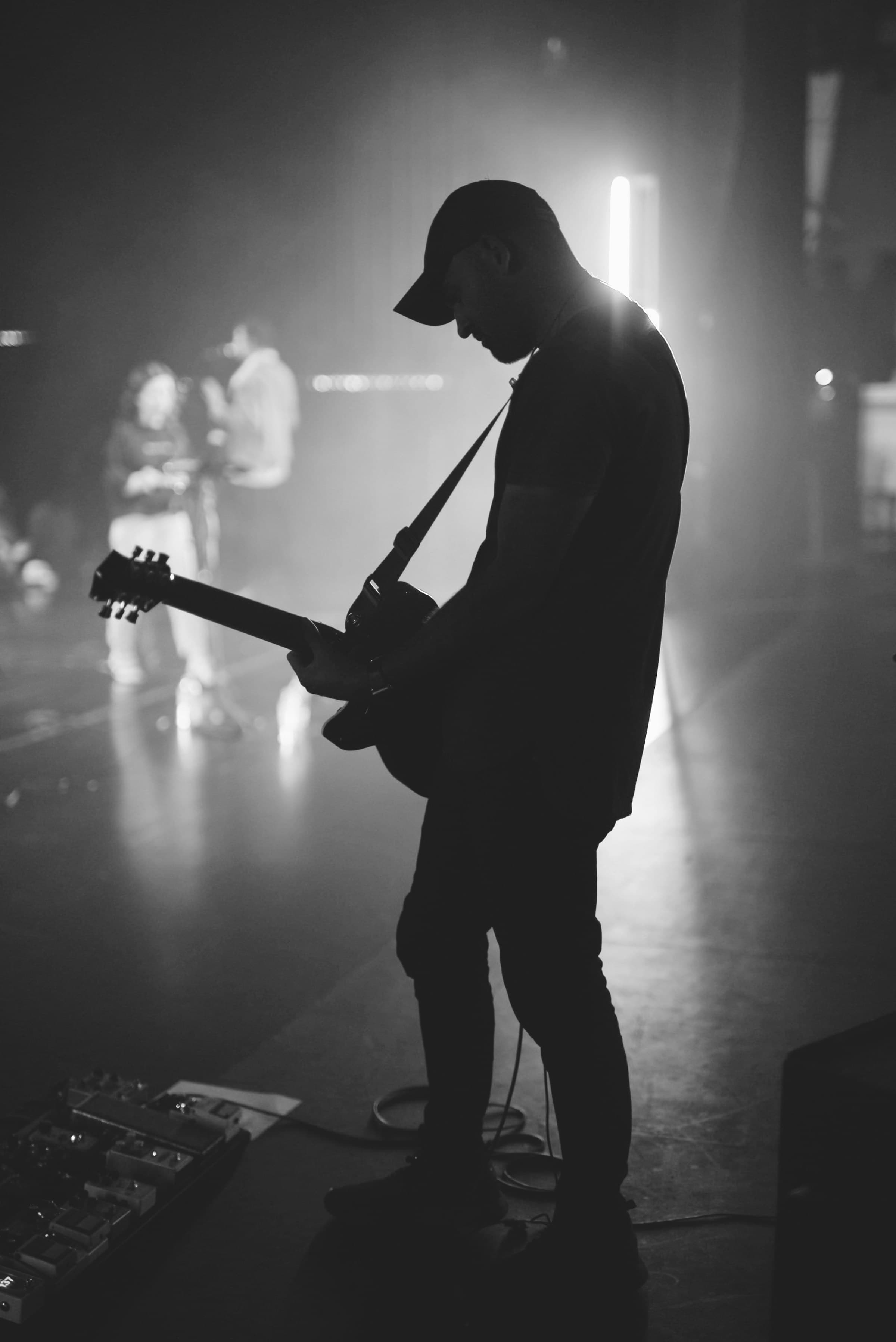Guitarist performing on a dark stage